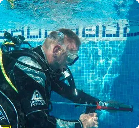 Diver performing pool leak detection