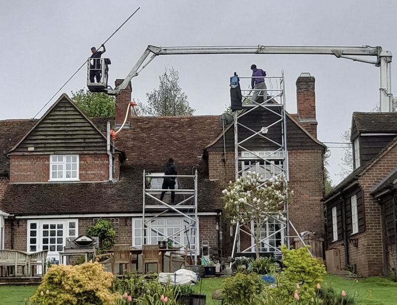 The Roof Moss Cleaners using cherry picker and scaffolding to clean roof safely and professionally in {{TOWN}}, {{COUNTY}}